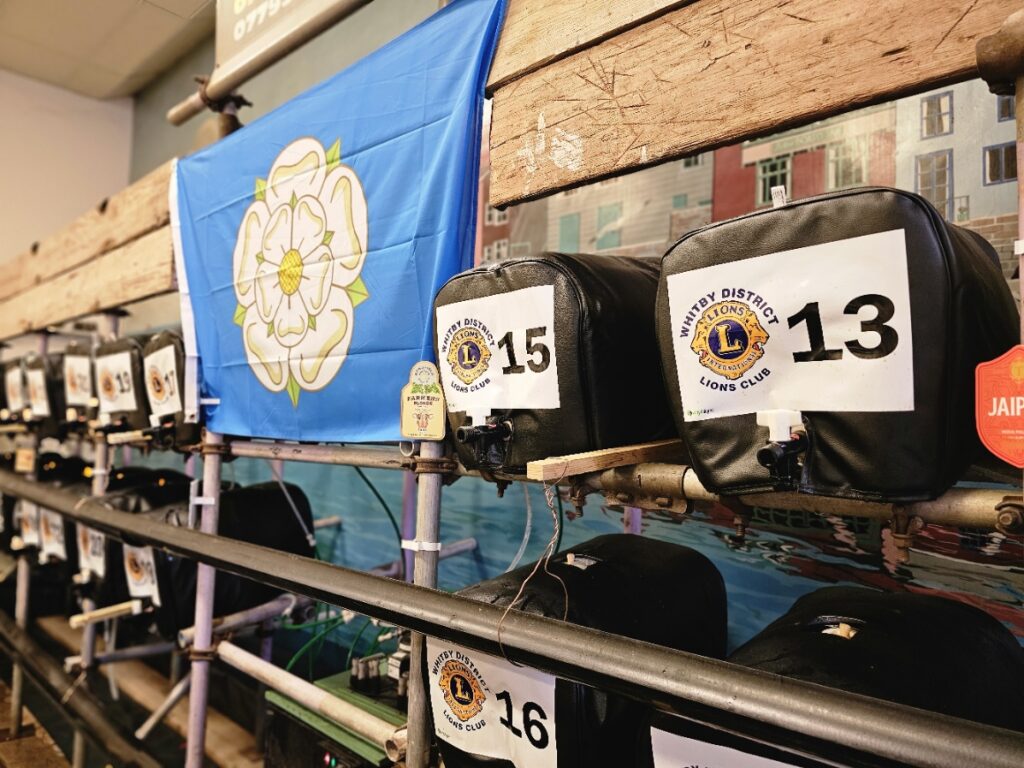 Yorkshire flag at the Whitby Beer Festival 2023 alongside a rack of cask ales.