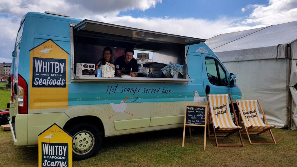 Whitby Seafood Scampi van id brightly decorated in a blue and sand colour colour scheme